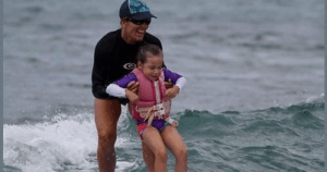 a person riding a surf board on a body of water